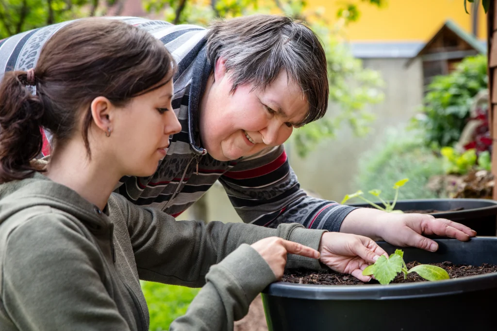 Young carer gardening with her patient